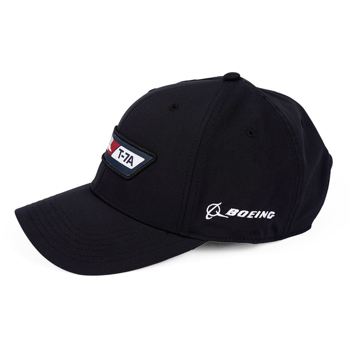 The Boeing T-7A Red Hawk Velocity Unisex Hat is a sleek black cap featuring an embroidered T-7A patch and the Boeing logo. This moisture-wicking statement piece is perfect for aviation enthusiasts, offering style and comfort in one.